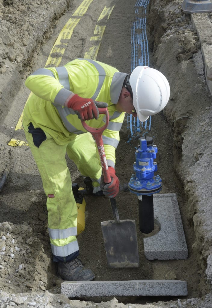 Bethell engineer installing a water connection