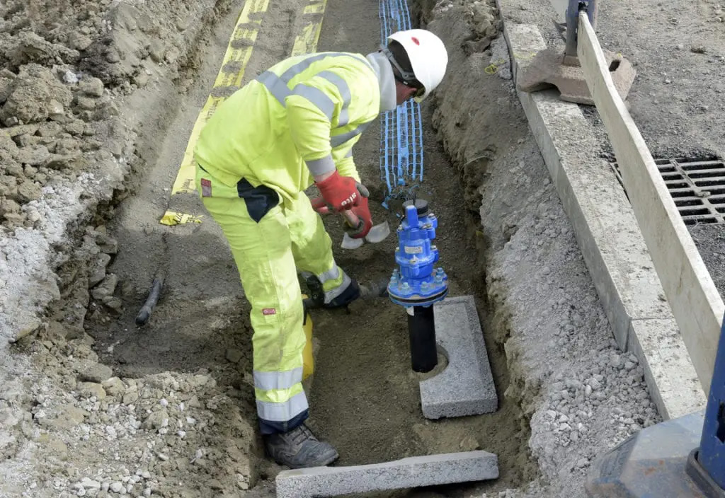 Bethell engineer installing a water connection