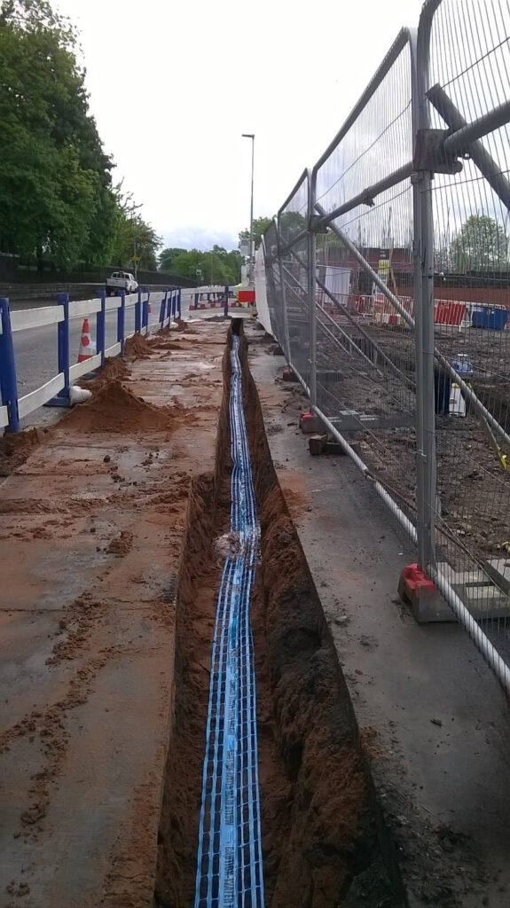 Water pipes laid in a trench beside a highway