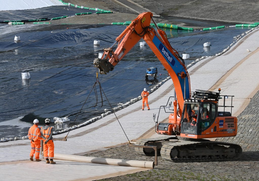 Photo of an excavator rolling out material