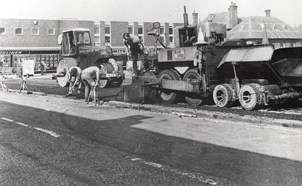 Historic photo of Bethell laying tarmac on a highway