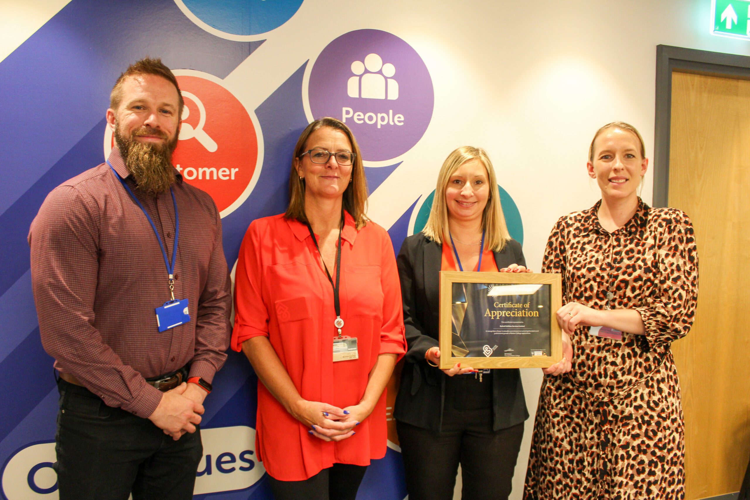 A group of people with an award in an office