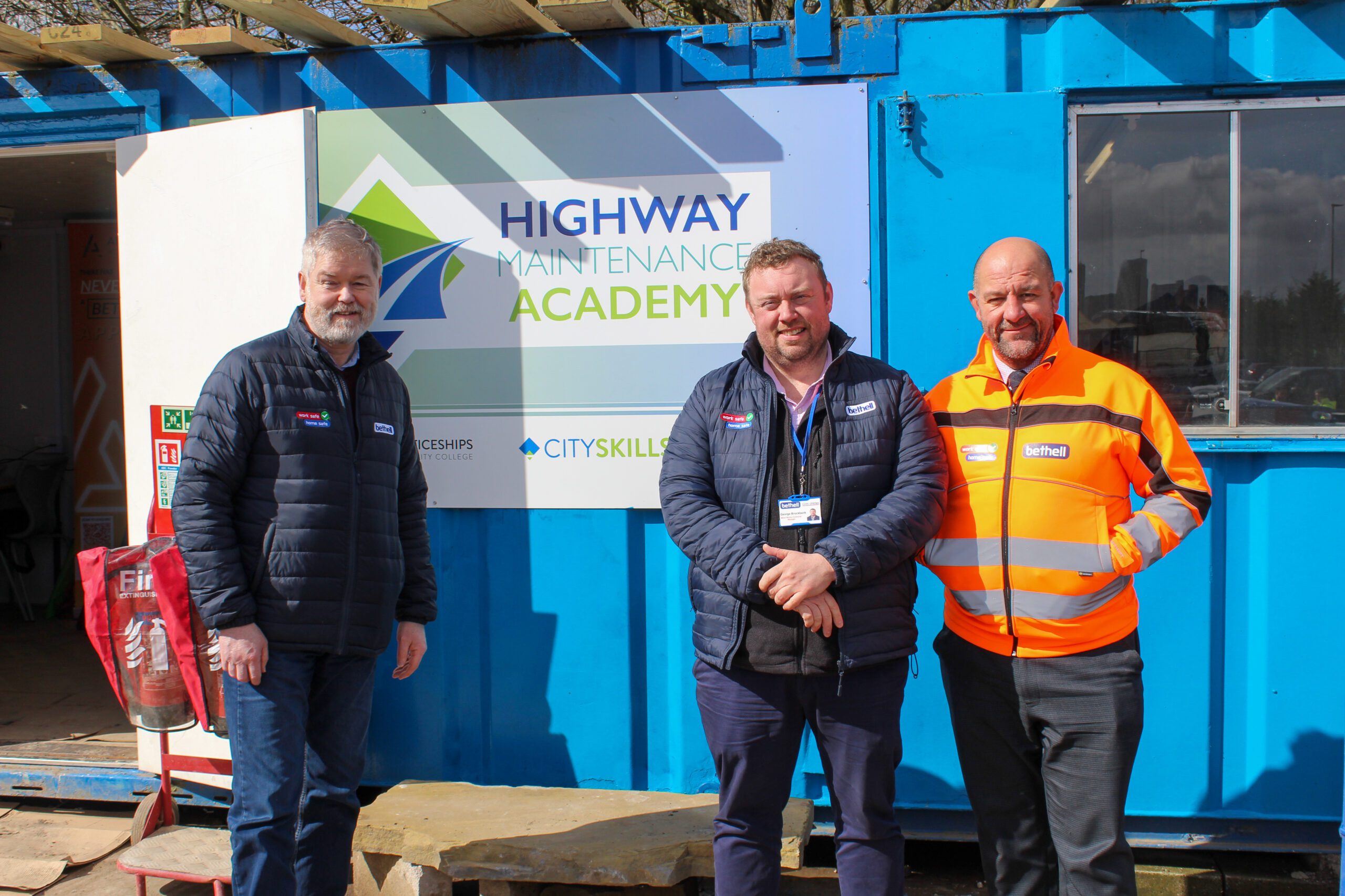 A group of people outside a training academy