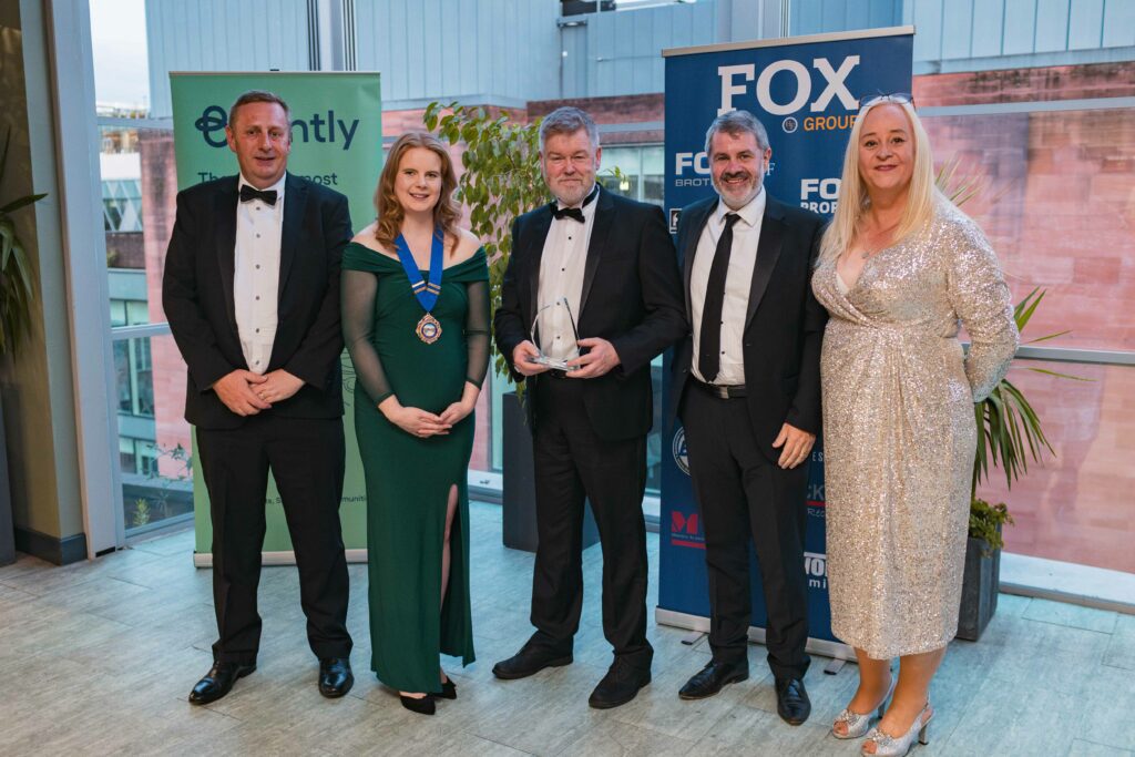 A group accepting an award at an industry awards ceremony