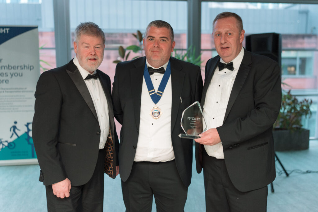 A group accepting an trophy at an industry award ceremony