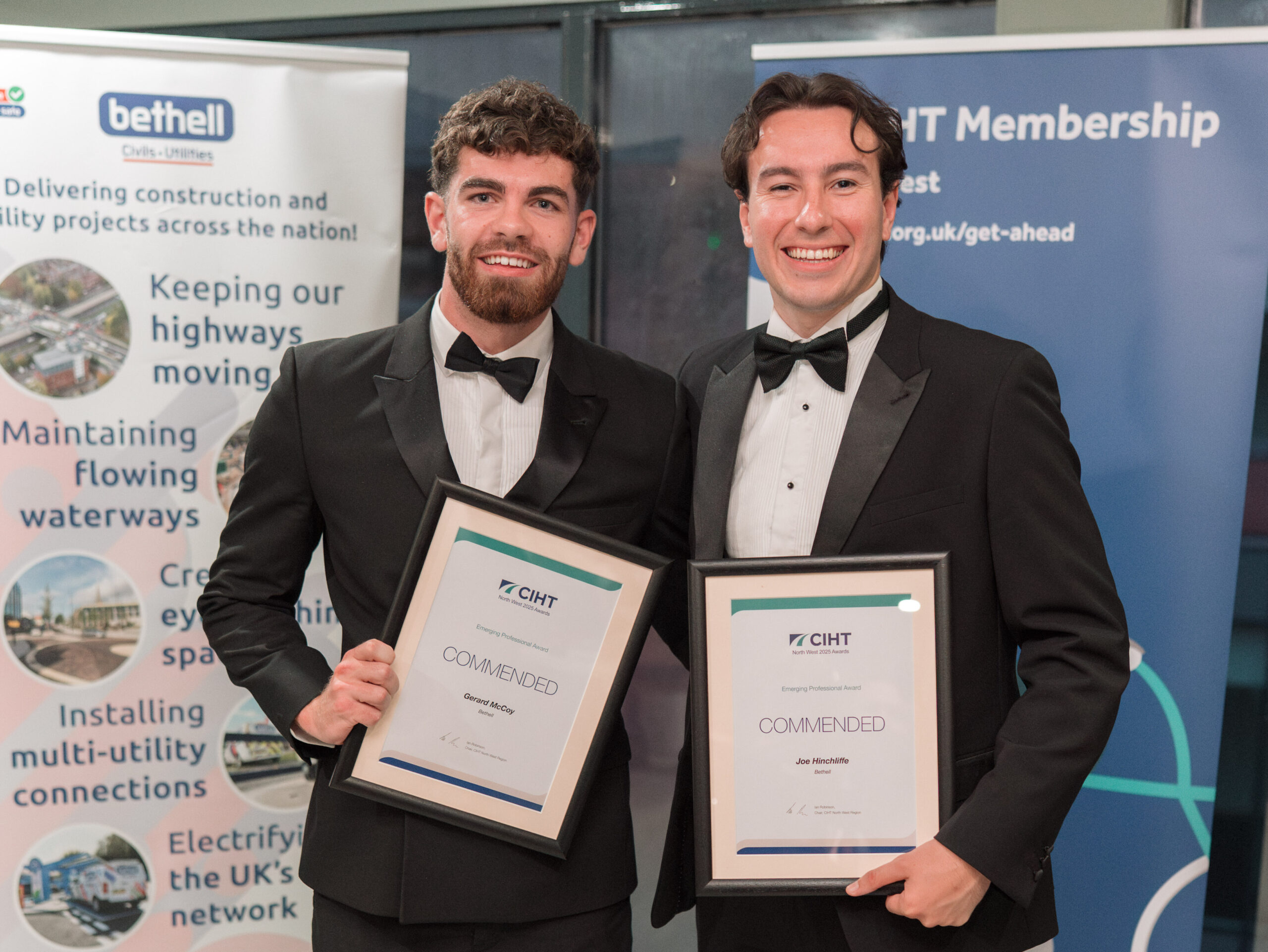 Two people with awards at an industry awards ceremony