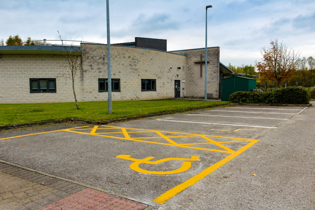 A school car park with a disabled parking bay