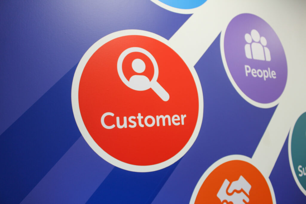 Close up of red "customer" value on wall