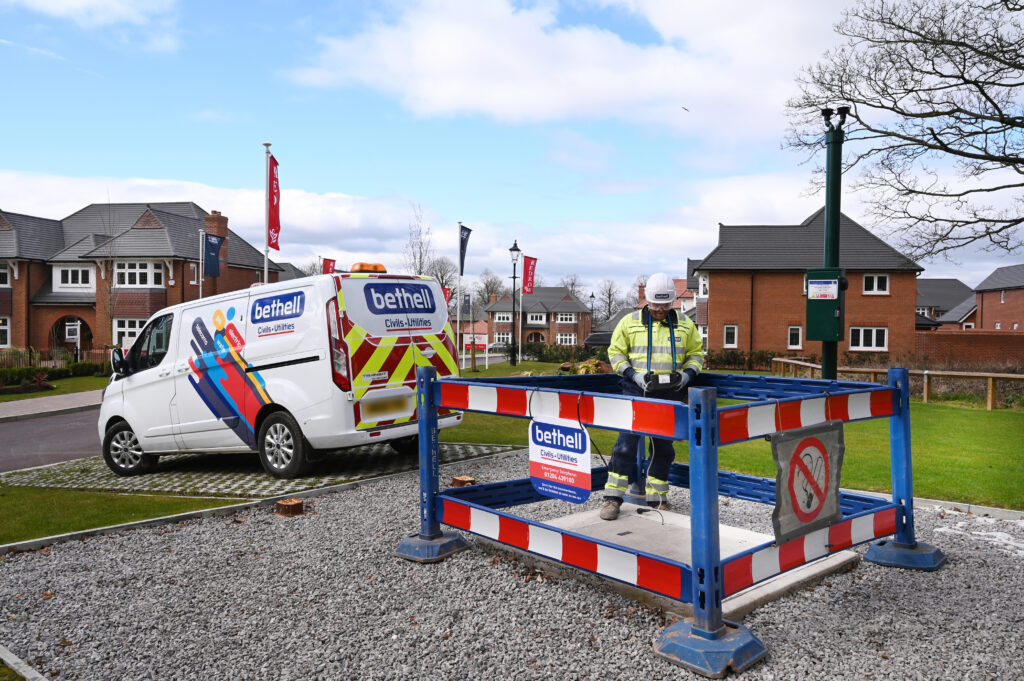 An operative in yellow PPE in a barriered area conducting a gas pressure test