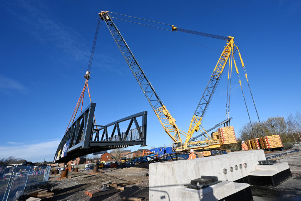 A crane lifting a bridge into place